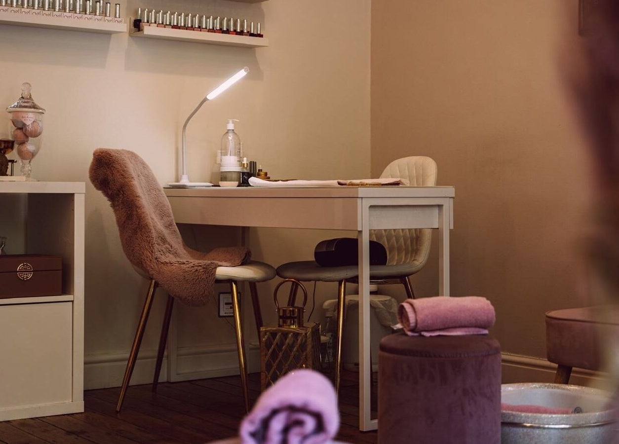 Manicure station with plush chairs at RJ Beauty, Halifax, England, GB; a relaxing beauty retreat.