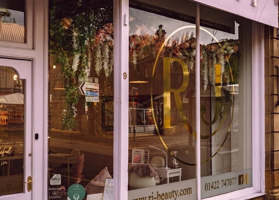 Elegant exterior of RJ Beauty in Halifax, England, GB showcasing floral decor and inviting atmosphere.