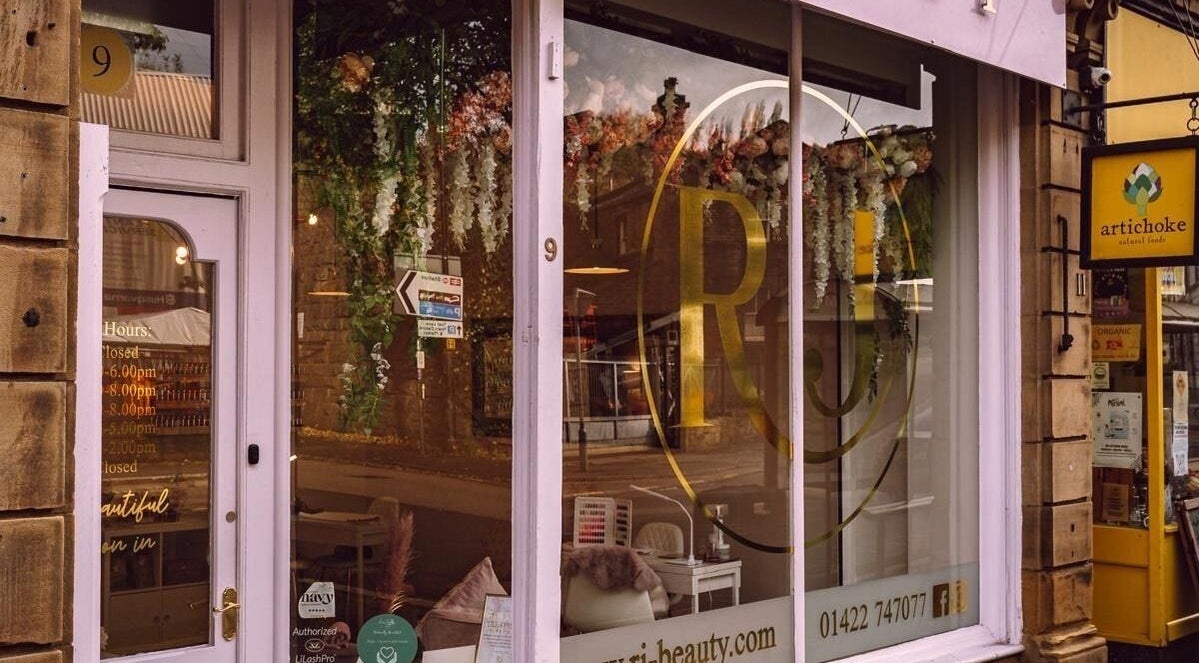 Elegant exterior of RJ Beauty in Halifax, England, GB showcasing floral decor and inviting atmosphere.