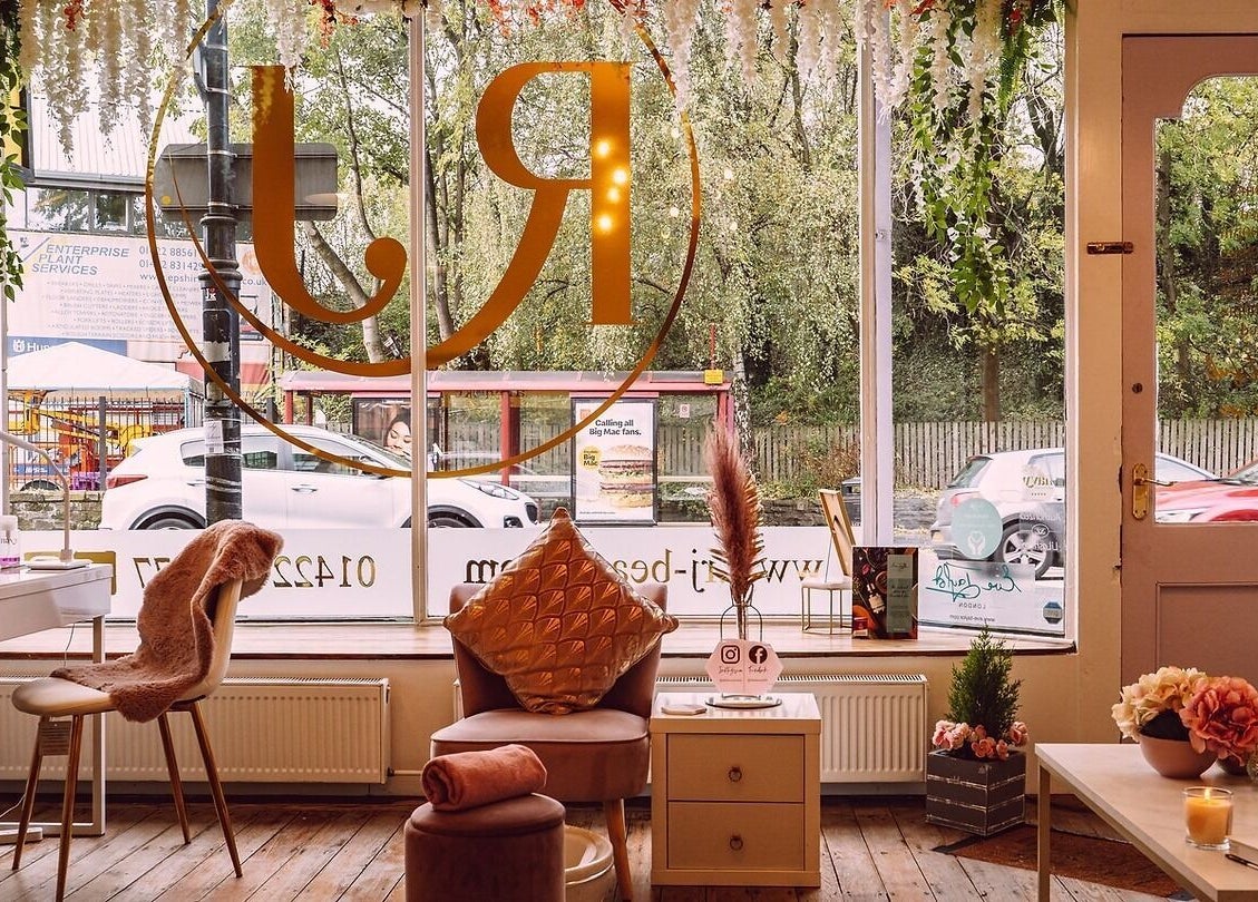 Inviting interior of RJ Beauty in Halifax, England, GB with plush seating, decor, and natural lighting.
