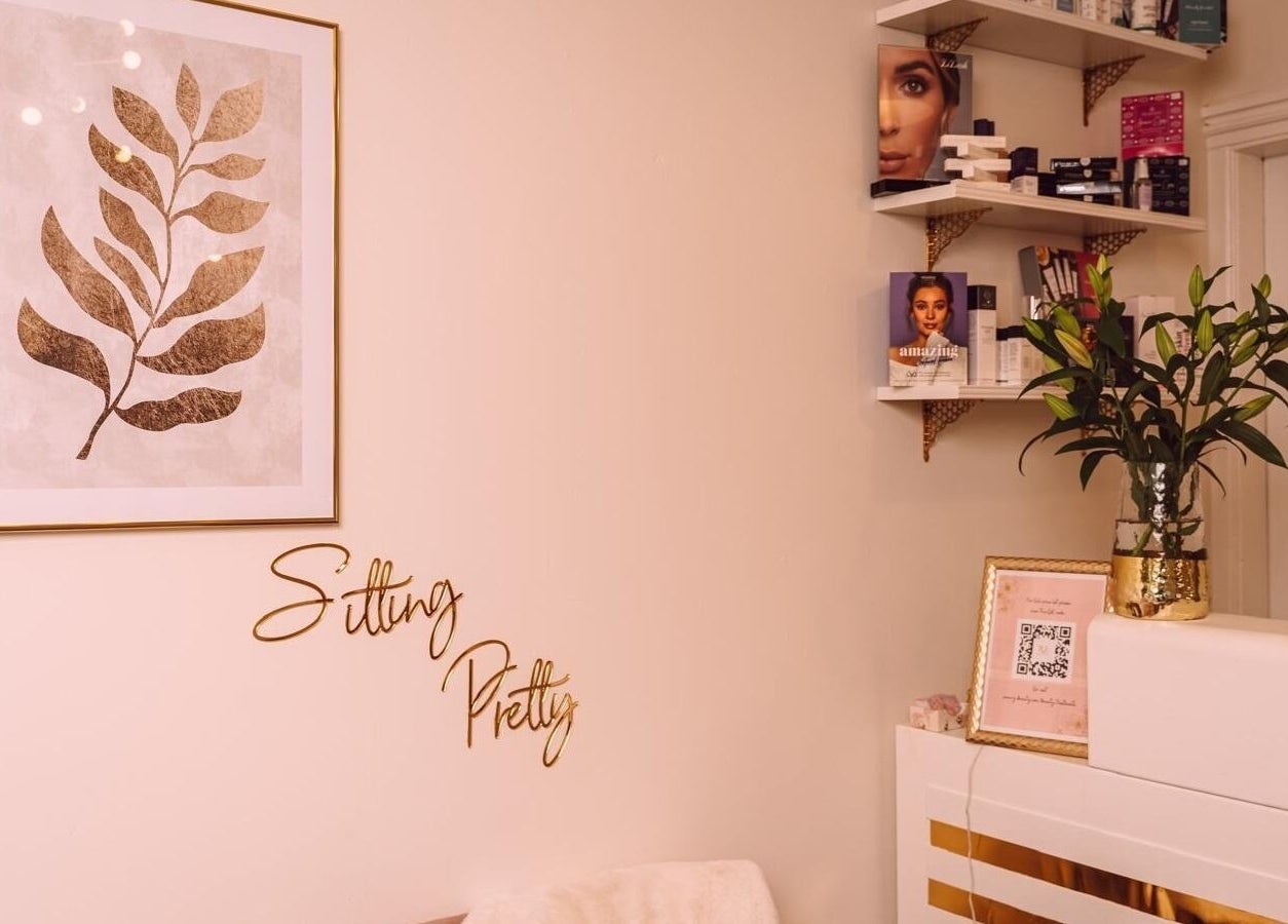 Elegant interior of RJ Beauty, Halifax, featuring stylish wall art and beauty products on display.