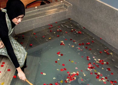 A woman enjoys a petal bath at Roseville Therapy Centre & Spa, Kota Bharu, Kelantan, MY.