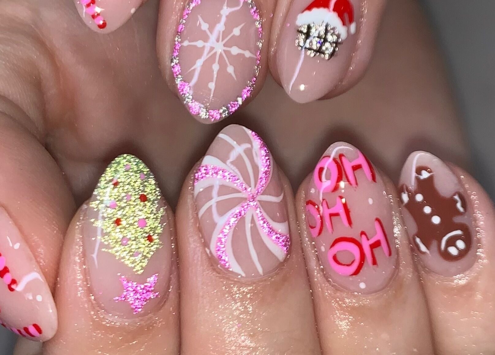 Festive holiday nail art at Luxx Nails & Spa, Canonsburg, Pennsylvania, US. Features candy cane and gingerbread designs.