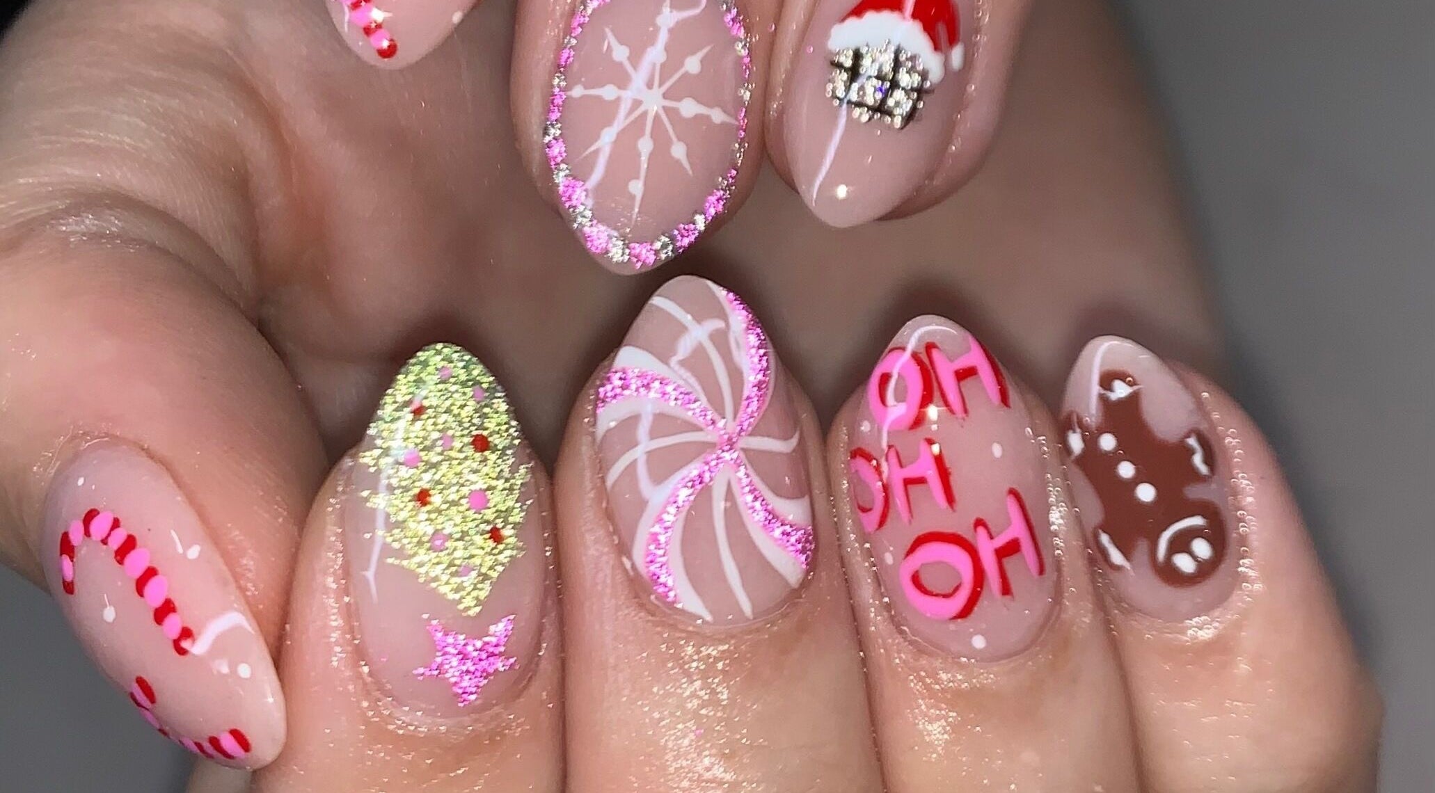Festive holiday nail art at Luxx Nails & Spa, Canonsburg, Pennsylvania, US. Features candy cane and gingerbread designs.
