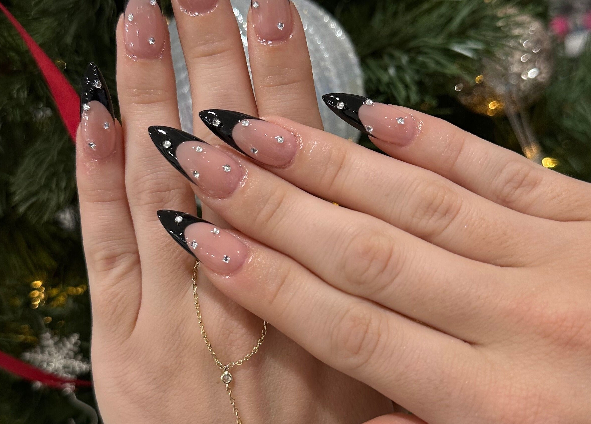 Elegant black-tipped nails with rhinestones at Luxx Nails & Spa, Canonsburg, Pennsylvania, US.