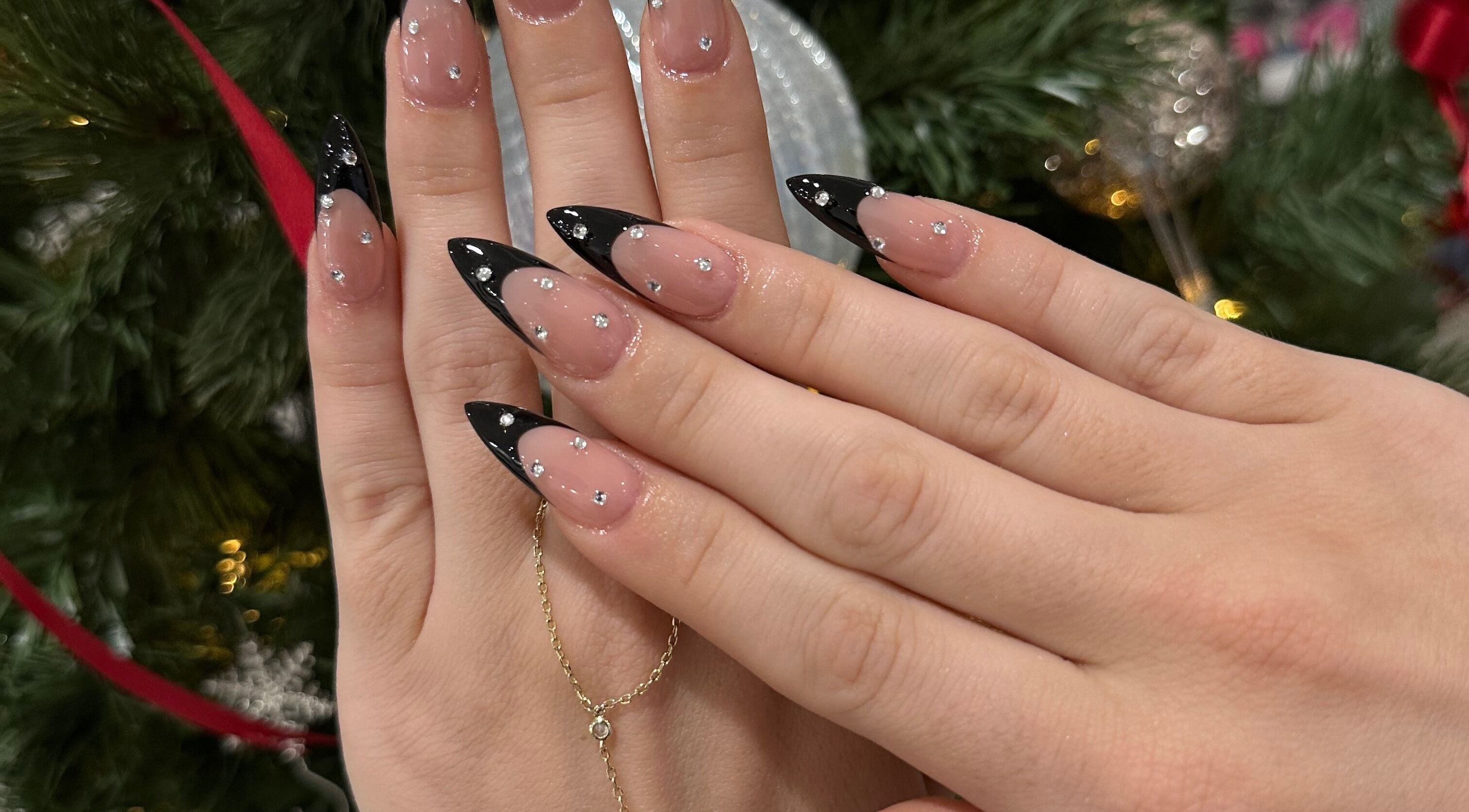 Elegant black-tipped nails with rhinestones at Luxx Nails & Spa, Canonsburg, Pennsylvania, US.