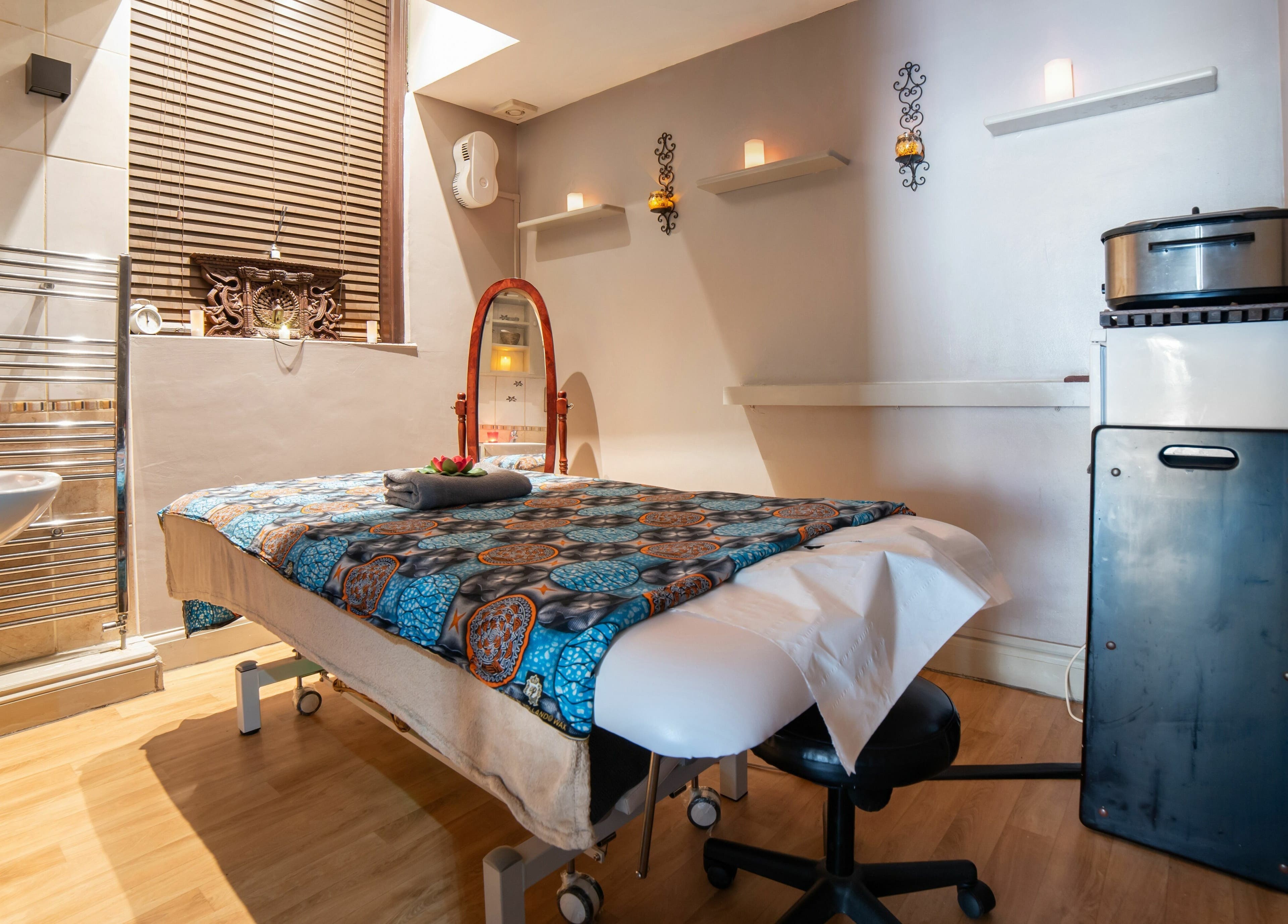 Tranquil massage room at Himalayan Springs Spa & Massage Centre, London, England, GB, featuring elegant decor.