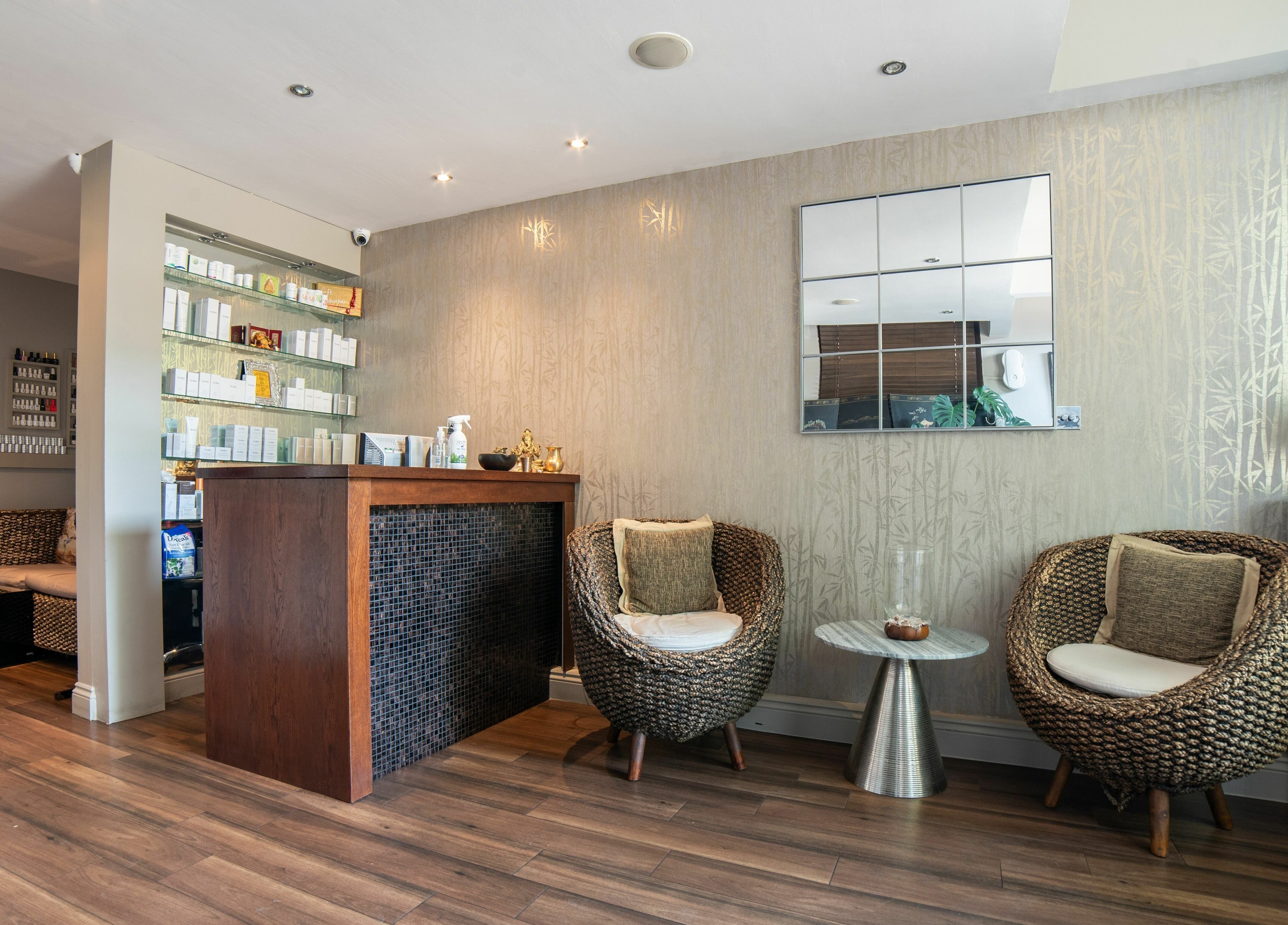 Elegant lobby of Himalayan Springs Spa & Massage Centre in London, England, GB with cozy woven chairs and soothing decor.
