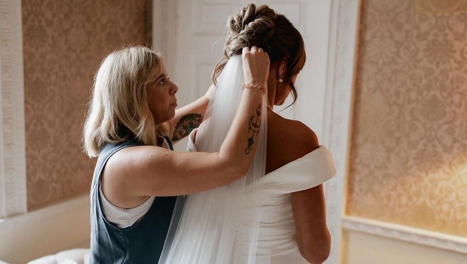 Hair stylist perfecting a bride's look at Rogue & Vow, Blidworth, England, GB.