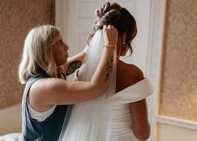 Hair stylist perfecting a bride's look at Rogue & Vow, Blidworth, England, GB.