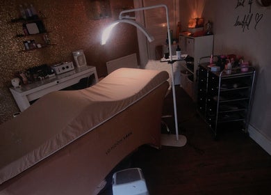 Cozy treatment room at Jos Beauty Cabin, Alexandria, Scotland, GB, featuring stylish decor and a plush treatment bed.