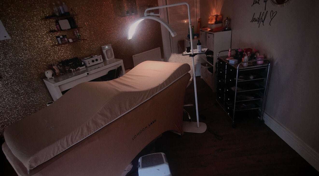 Cozy treatment room at Jos Beauty Cabin, Alexandria, Scotland, GB, featuring stylish decor and a plush treatment bed.
