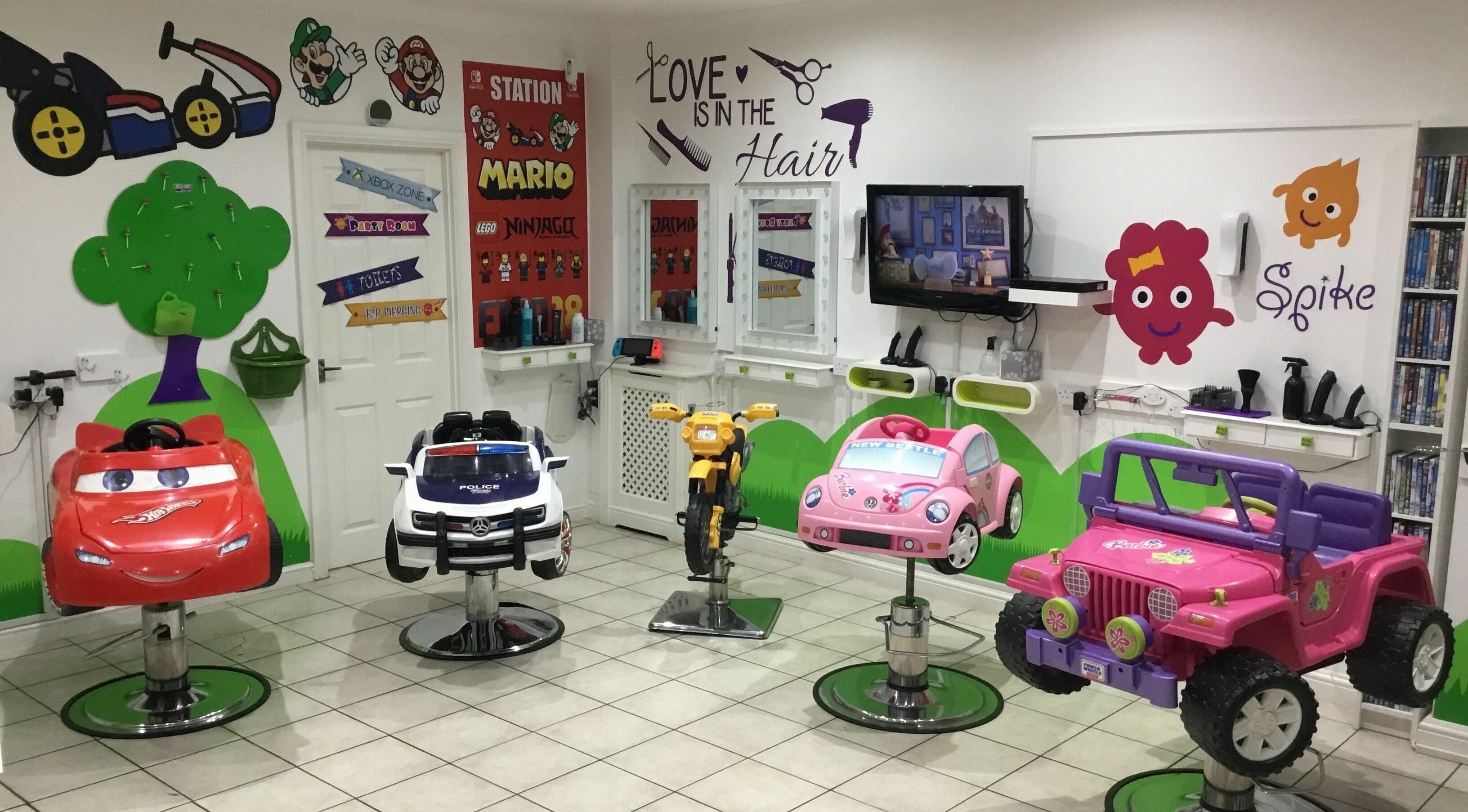 Fun car-themed chairs at Fidgets the Salon for Kids Whitley Bay, Whitley Bay, England, GB, creating a lively atmosphere.