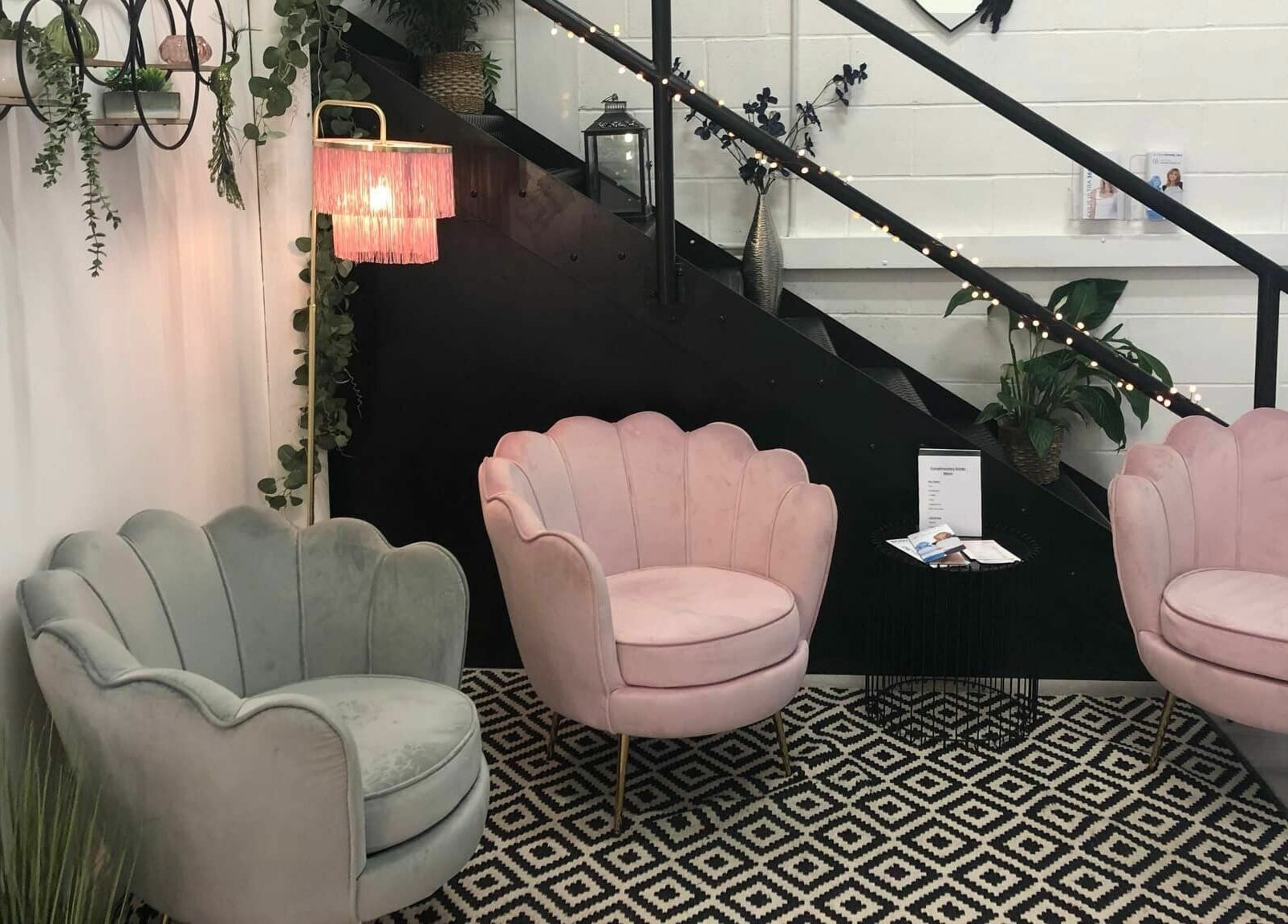 Chic seating area at Hayley’s Hair Removal and Aesthetics in Poole, England, GB with plush chairs and soft lighting.