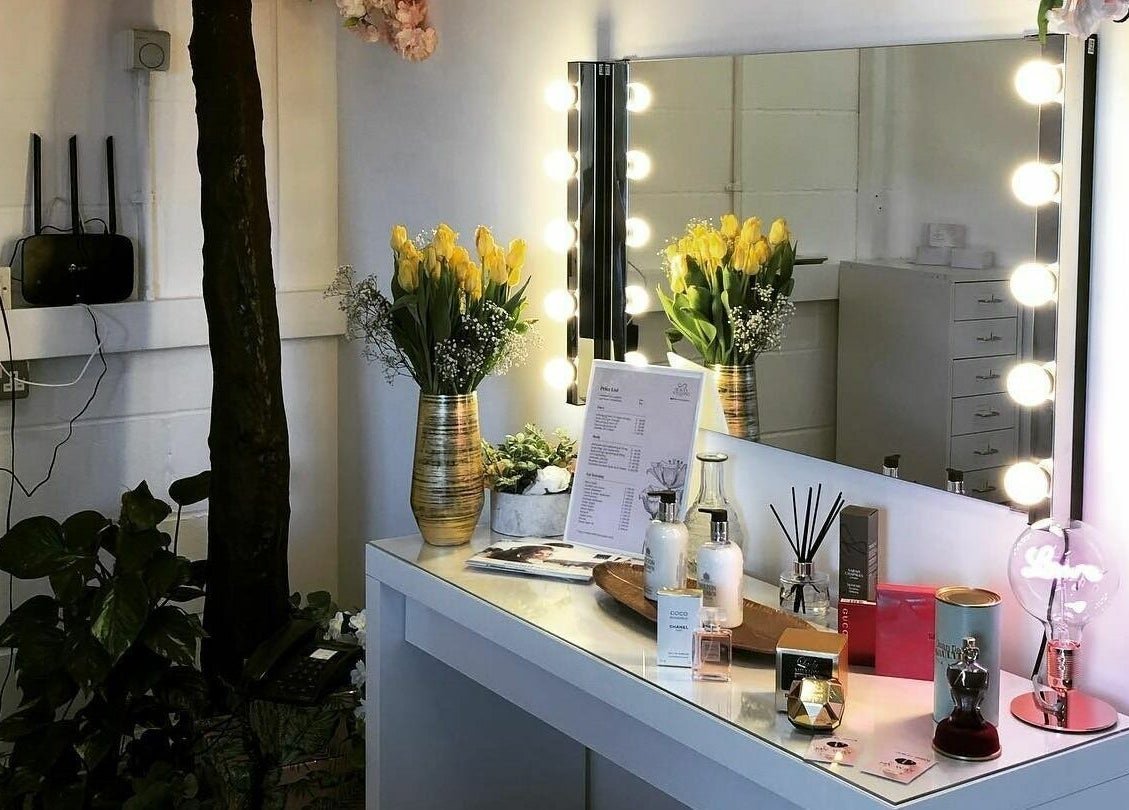 Stylish beauty vanity at Hayley’s Hair Removal and Aesthetics, Poole, England, GB, adorned with flowers and products.