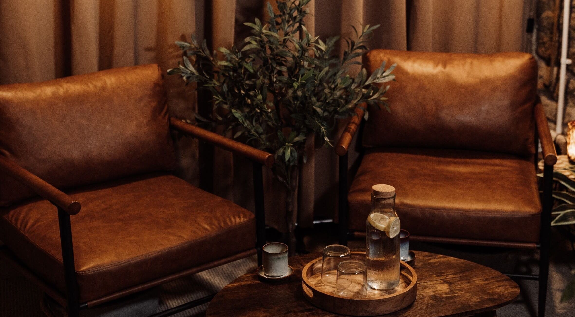 Relaxing seating area at House of Soul Feniscowles, Feniscowles, England, GB with leather chairs and table.