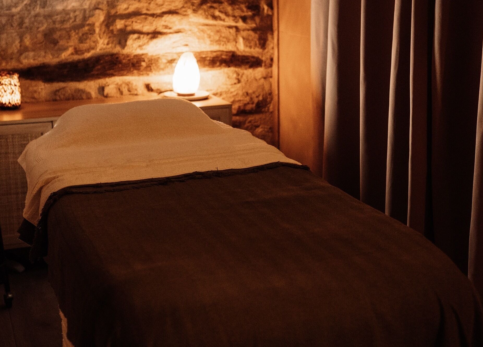 Cozy massage room at House of Soul Feniscowles, Feniscowles, England, GB with warm lighting and soft linens.