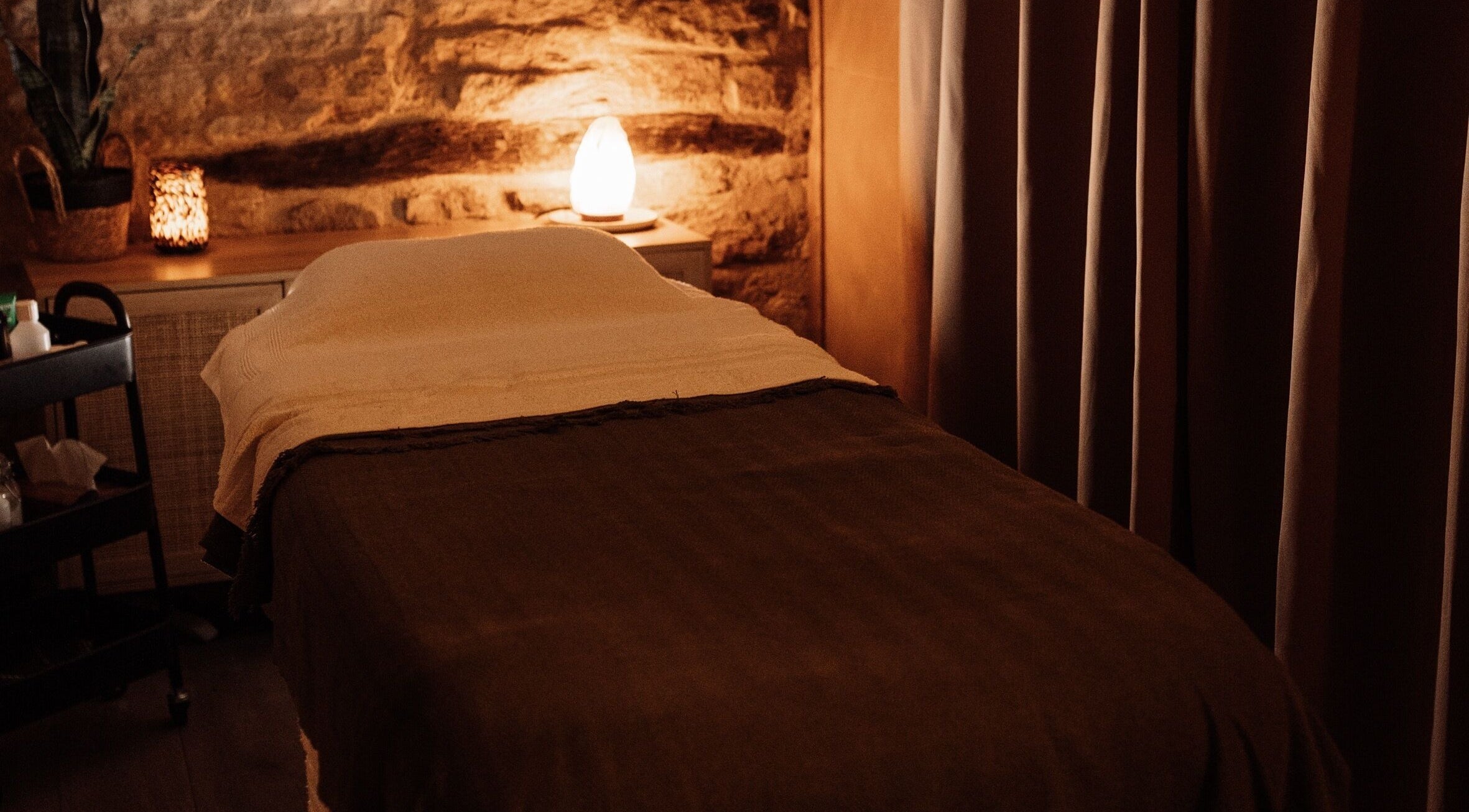 Cozy massage room at House of Soul Feniscowles, Feniscowles, England, GB with warm lighting and soft linens.