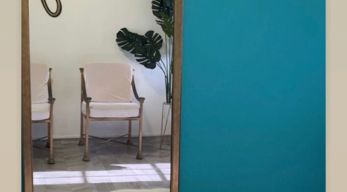 Stylish seating area at The Ikonic Glo, Prospect, Saint James, BB with vibrant decor and lush plant.