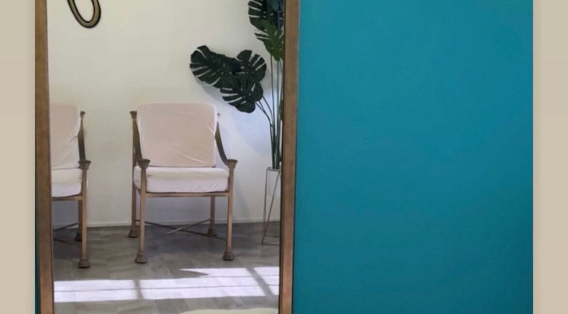 Stylish seating area at The Ikonic Glo, Prospect, Saint James, BB with vibrant decor and lush plant.