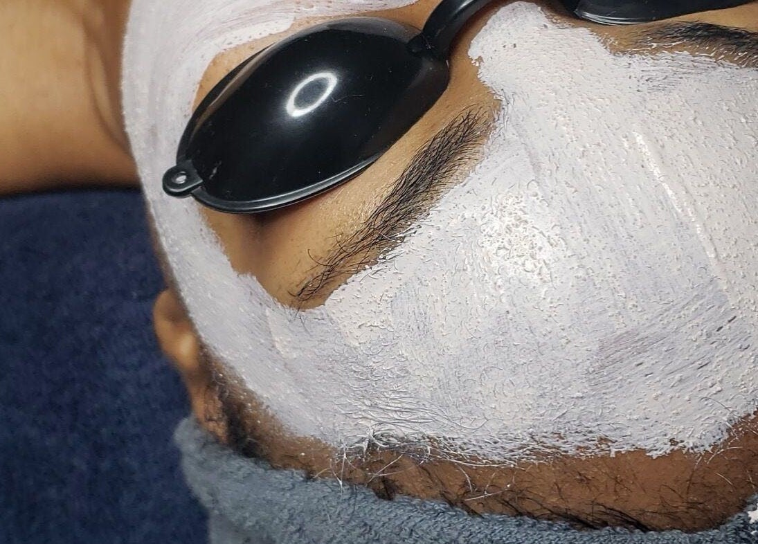 Facial treatment with white mask at The Ikonic Glo, Prospect, Saint James, BB, offering a serene spa experience.