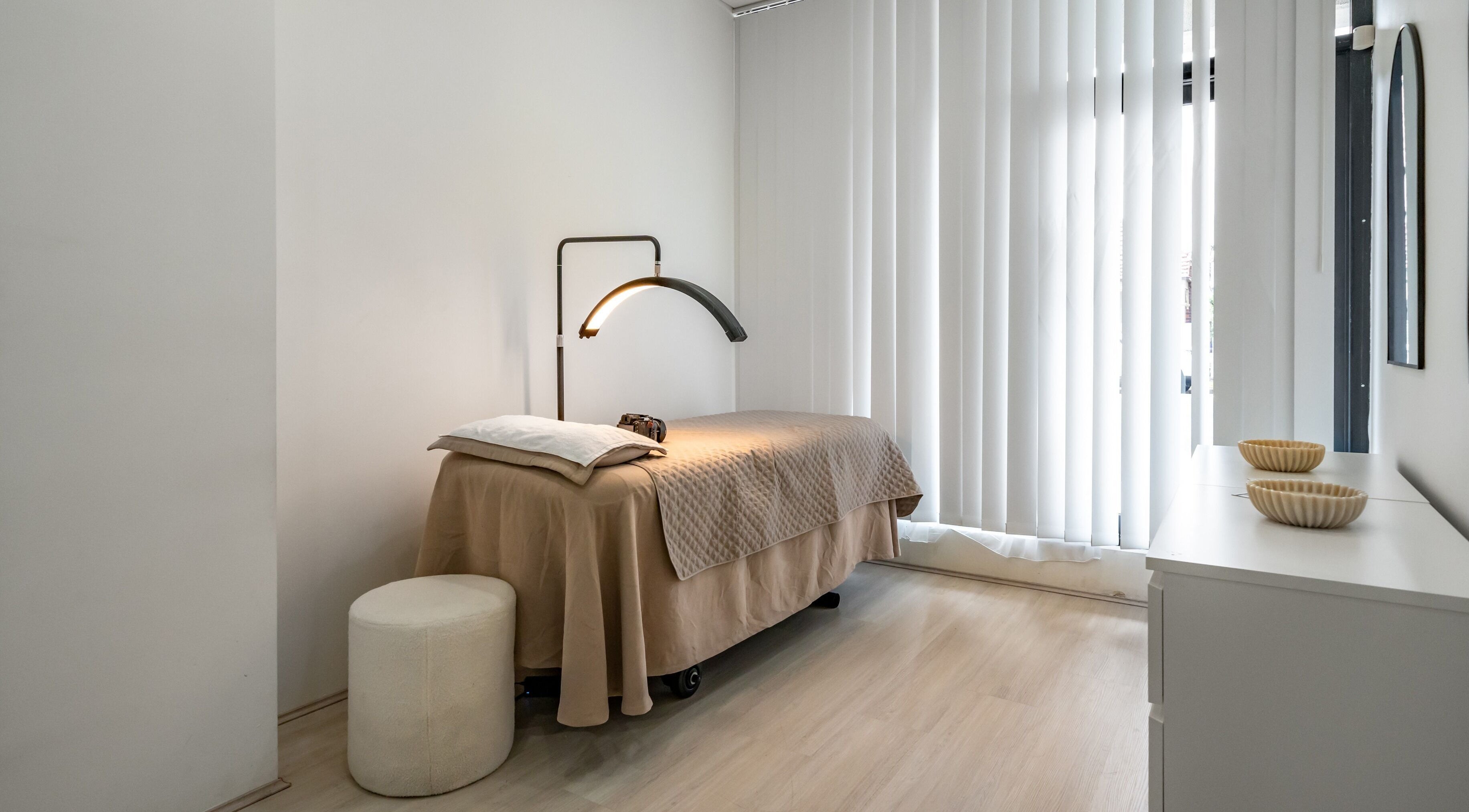 Tranquil treatment room at Luminous Skin by Amal, Rockdale, New South Wales, AU. Cozy bed and relaxing ambiance.