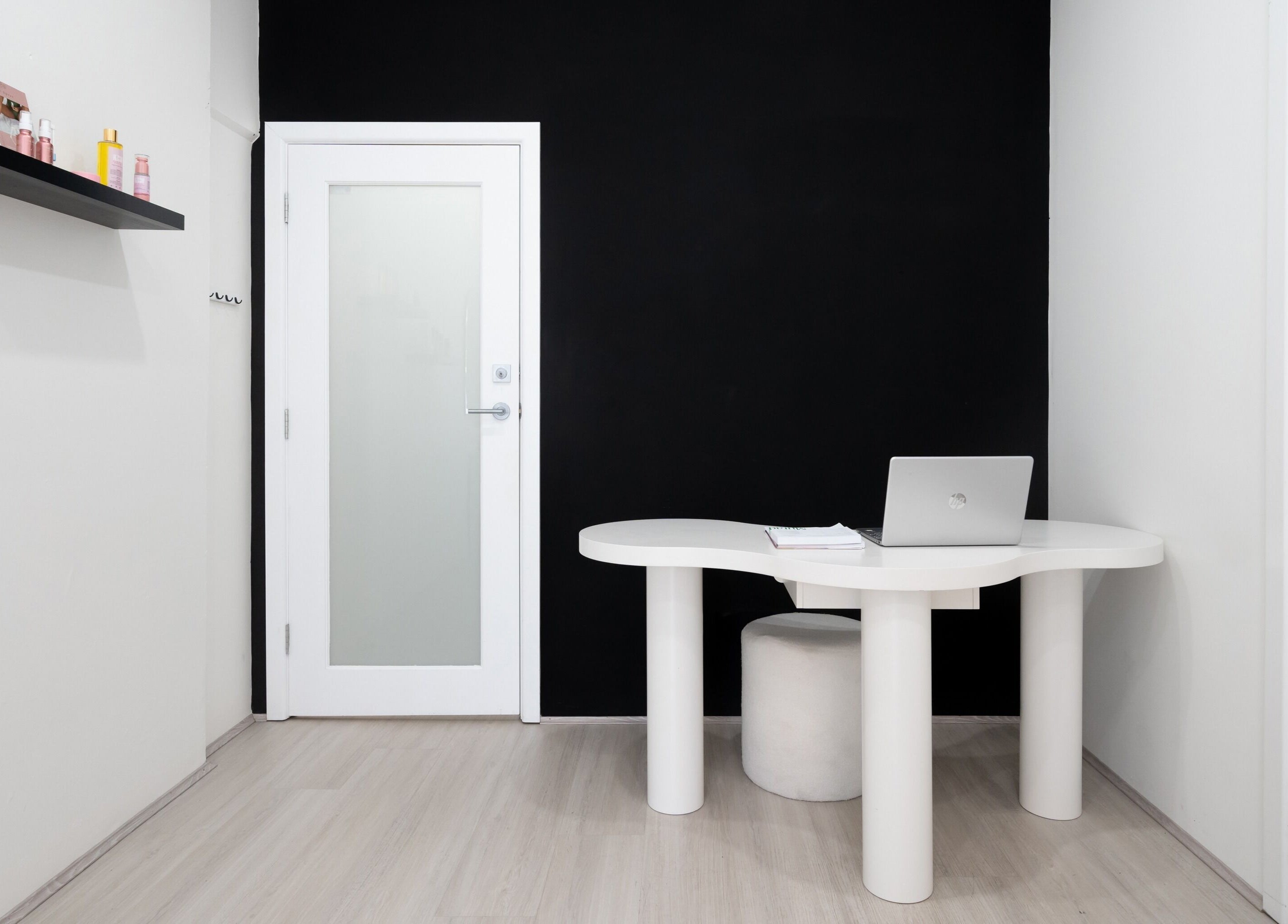 Modern office at Luminous Skin by Amal, Rockdale, New South Wales, AU featuring a sleek white table and laptop.