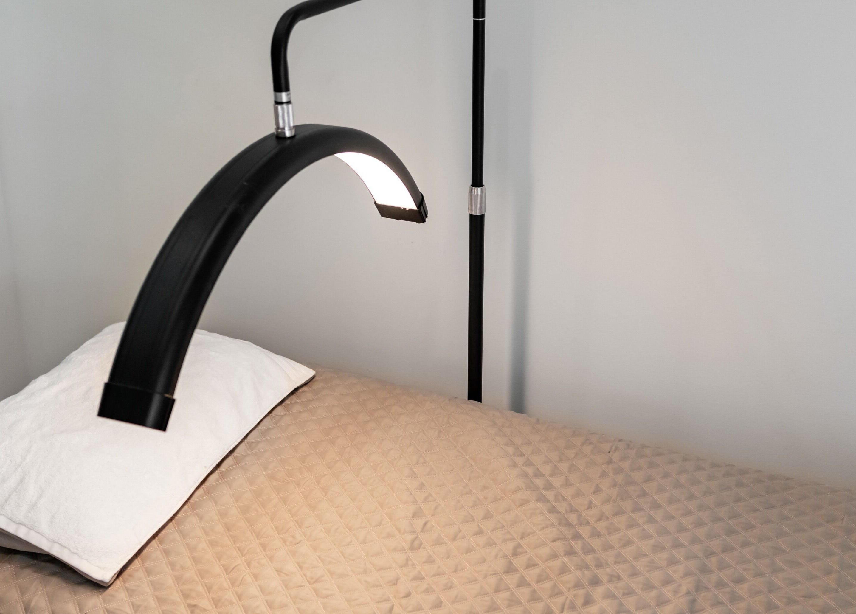 Modern treatment bed at Luminous Skin by Amal in Rockdale, New South Wales, AU, featuring sleek lighting.