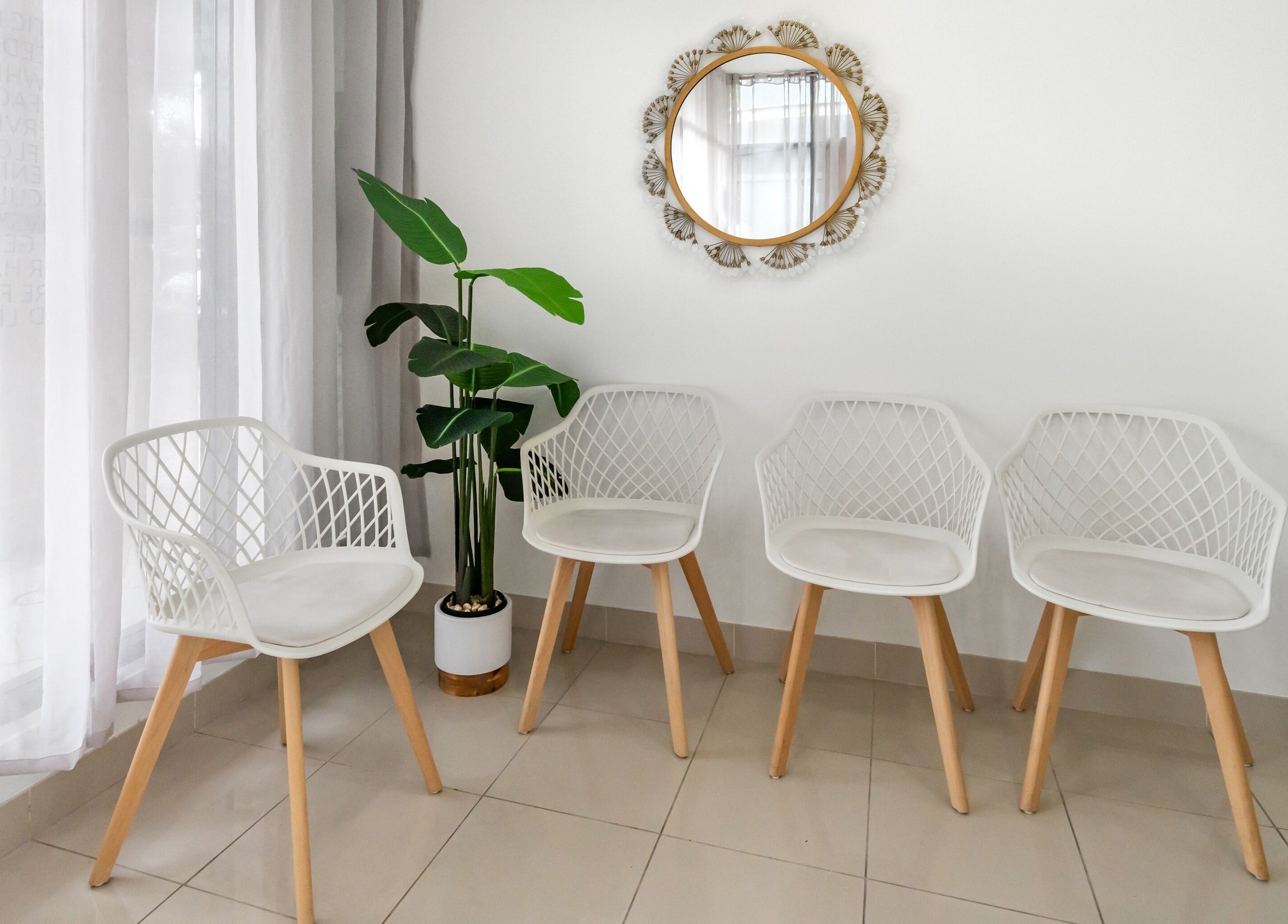 Modern waiting area at Luminous Skin by Amal, Rockdale, New South Wales, AU with white chairs and green plants.