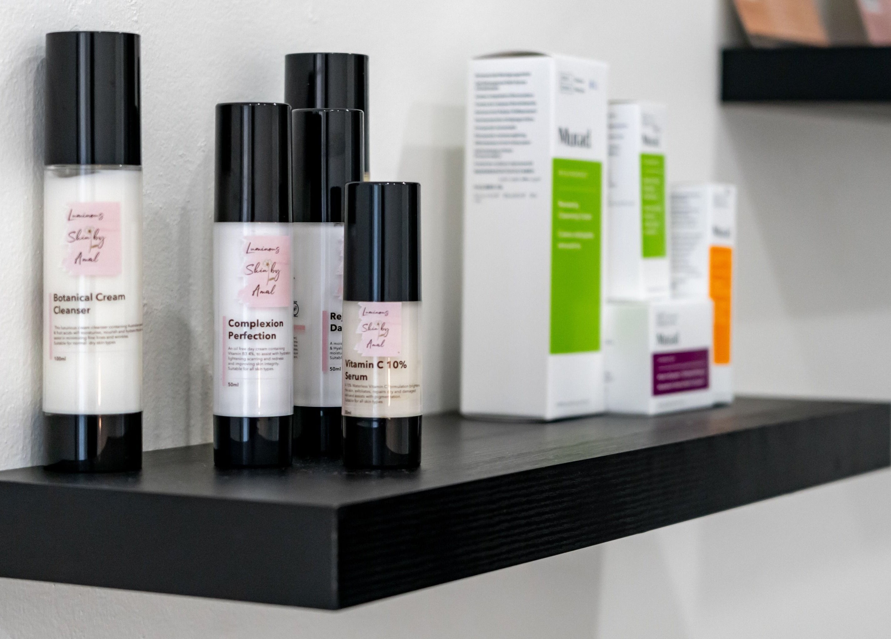 Skincare products on a shelf at Luminous Skin by Amal in Rockdale, New South Wales, AU.
