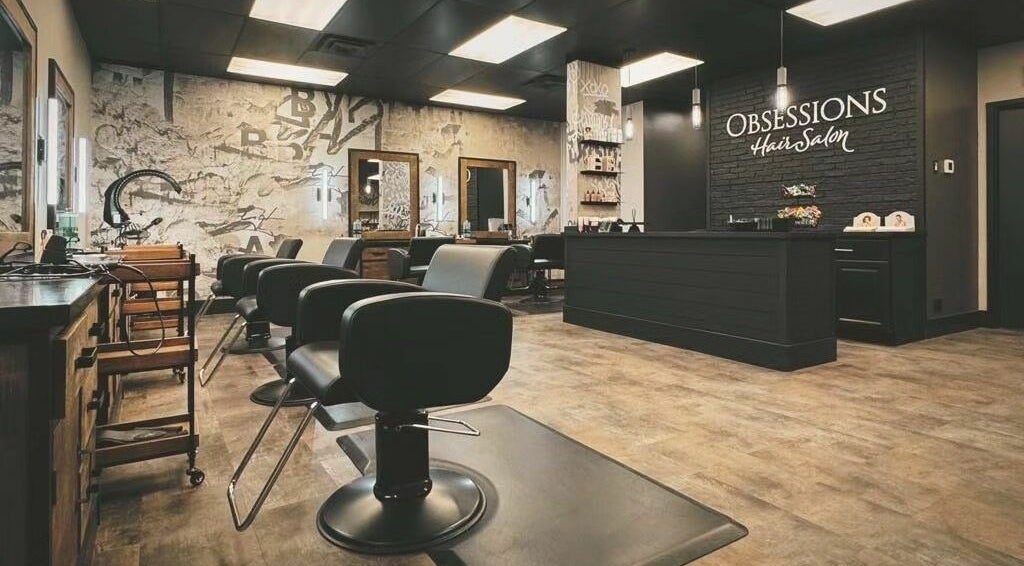 Chic interior of Obsessions Hair Salon in Brantford, Ontario, CA showcasing stylish chairs and black decor.