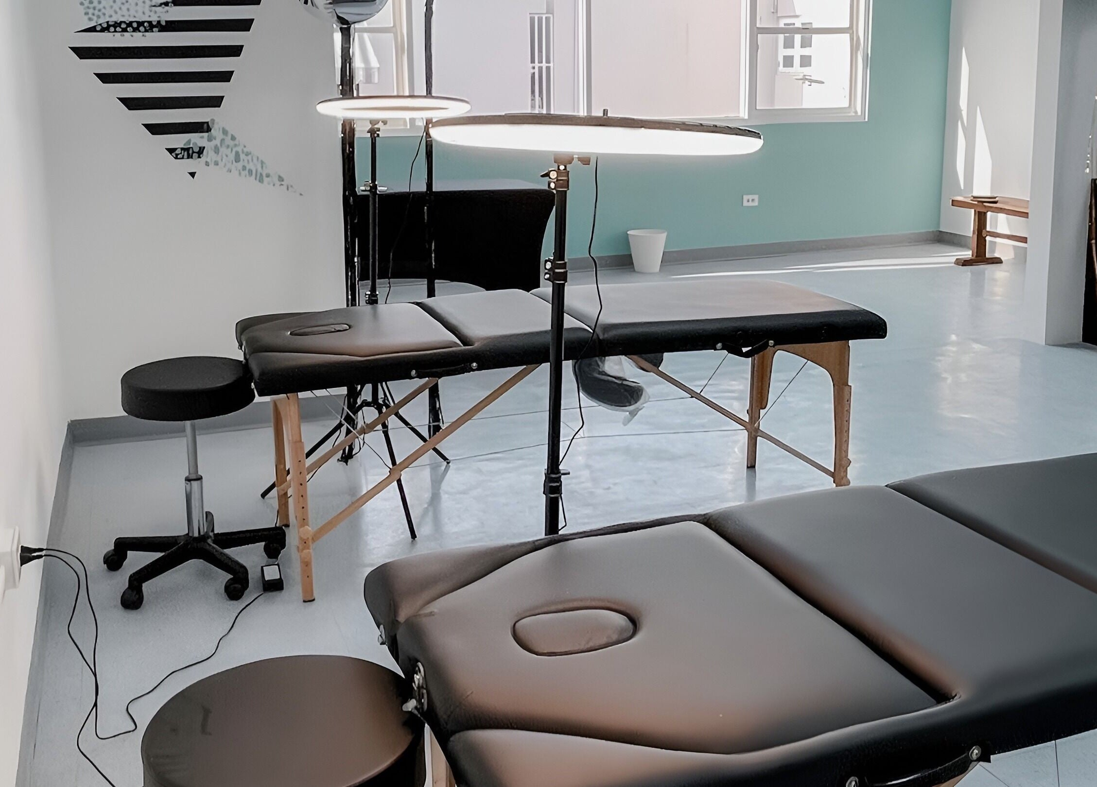 Contemporary treatment room at Millie Román Studio, San Juan, San Juan, PR, with massage tables and lighting.