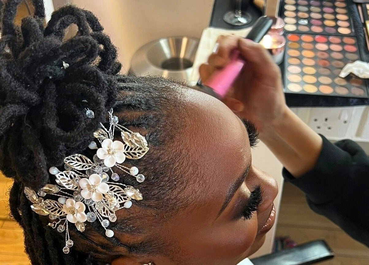 Intricate hair updo with floral accessories at Cheveux By Cindy, Bexleyheath, England, GB.