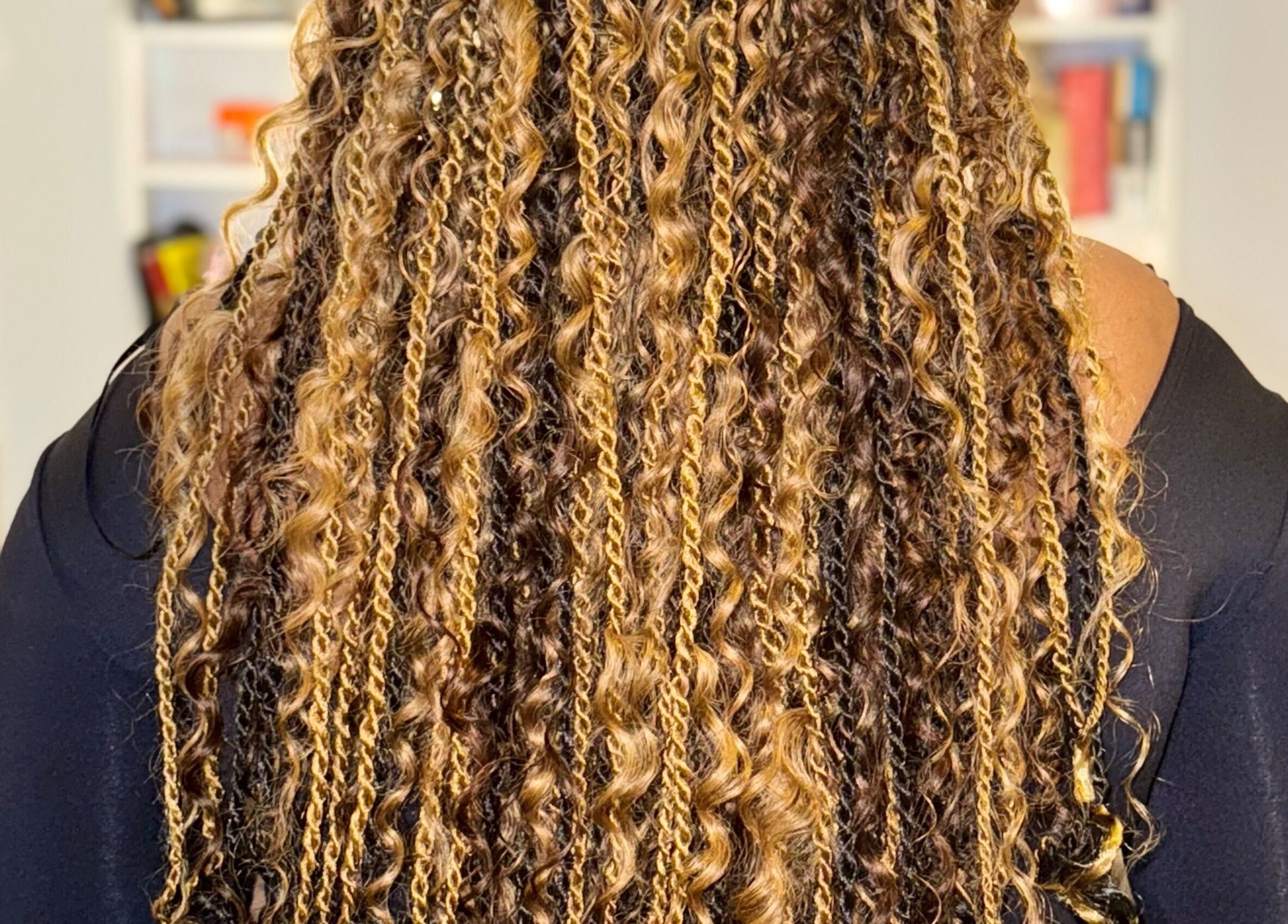 Detailed view of golden curls hairstyle at Cheveux By Cindy, Bexleyheath, England, GB.