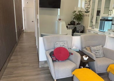 Relaxing area at Musi Studio, Richmond, BC with cozy grey chairs and vibrant yellow accents.