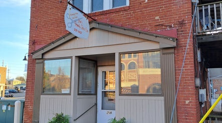 Hairbyscot exterior in Washington, Missouri, US featuring a quaint red-brick facade and welcoming entrance.