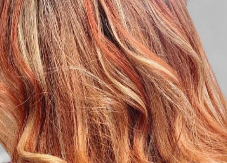 Vibrant red and orange hair design by Hairbyscot in Washington, Missouri, US, showcasing expert coloring techniques.