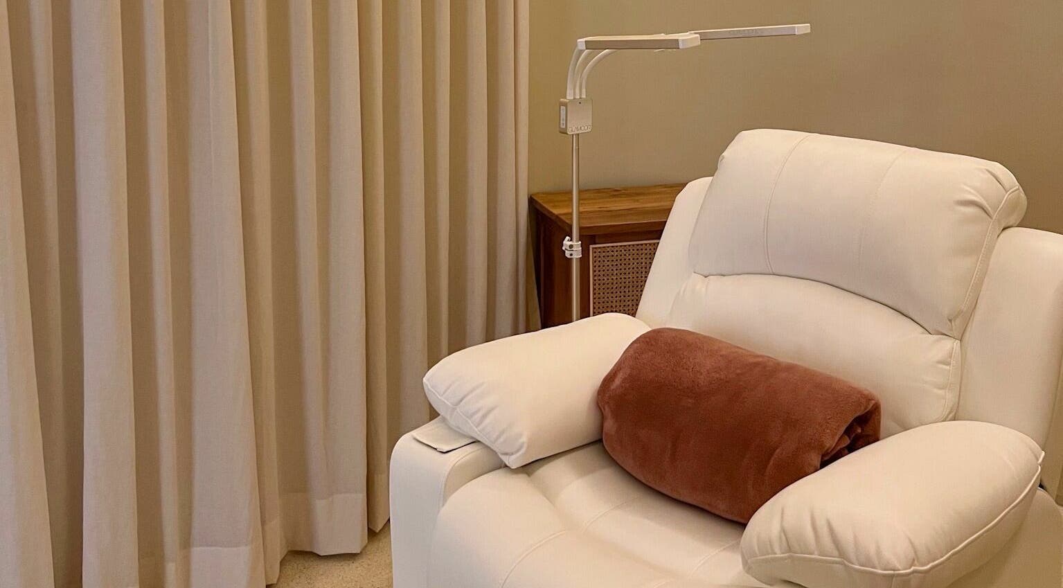 Comfortable white chair at LYLA Beauty Lounge, Kuala Lumpur, perfect for relaxation and wellness.