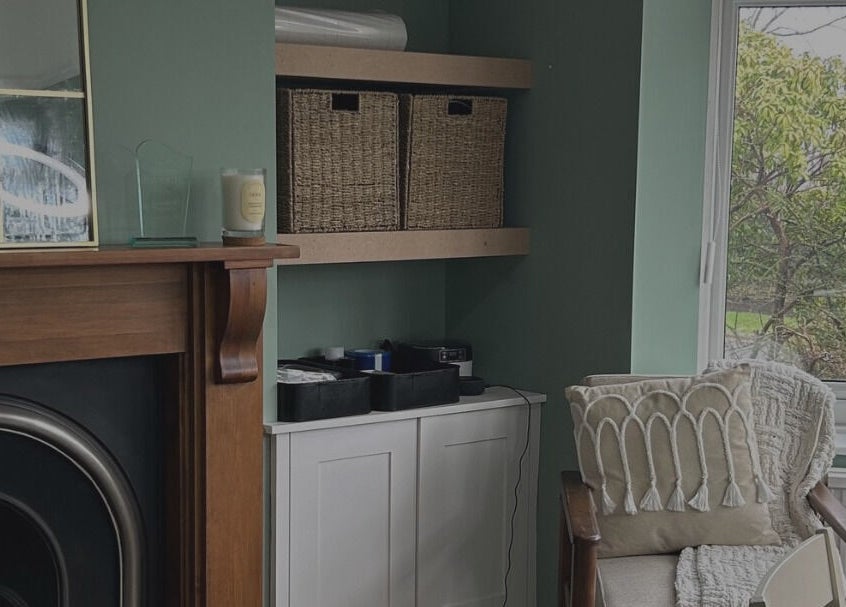 Comfortable lounge area at Glow Girl Club and Megan Tucker PMU in Morriston, Wales, GB with chair and fireplace.