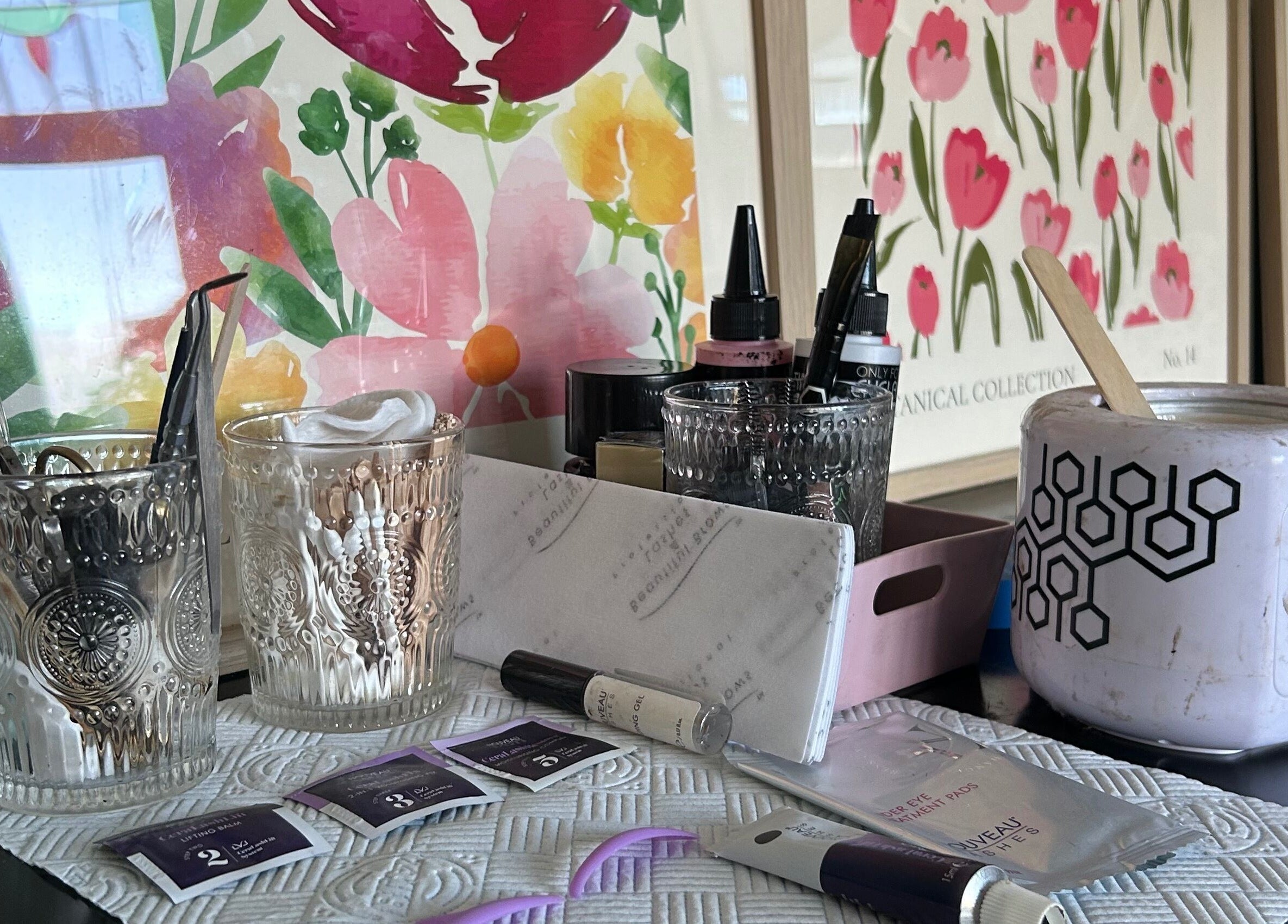 Beauty tools and products at Glow Girl Club and Megan Tucker PMU, Morriston, Wales, GB, with floral decor.