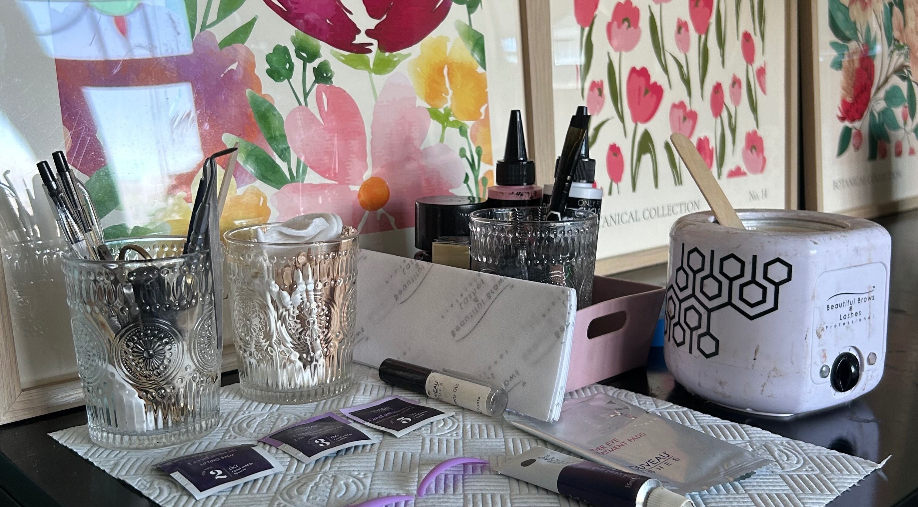 Beauty tools and products at Glow Girl Club and Megan Tucker PMU, Morriston, Wales, GB, with floral decor.