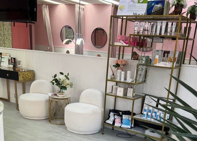 Elegant lounge at Haus of Beauty, Waverley NSW, AU showcasing product display and cozy seating.