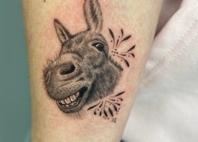 Detailed donkey tattoo by Viviana Sp Tattoo Artist, Melbourne, Victoria, AU. Realistic donkey design with playful elements.