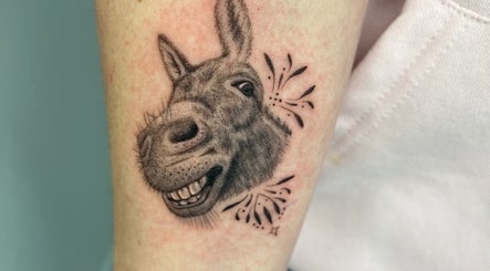 Detailed donkey tattoo by Viviana Sp Tattoo Artist, Melbourne, Victoria, AU. Realistic donkey design with playful elements.