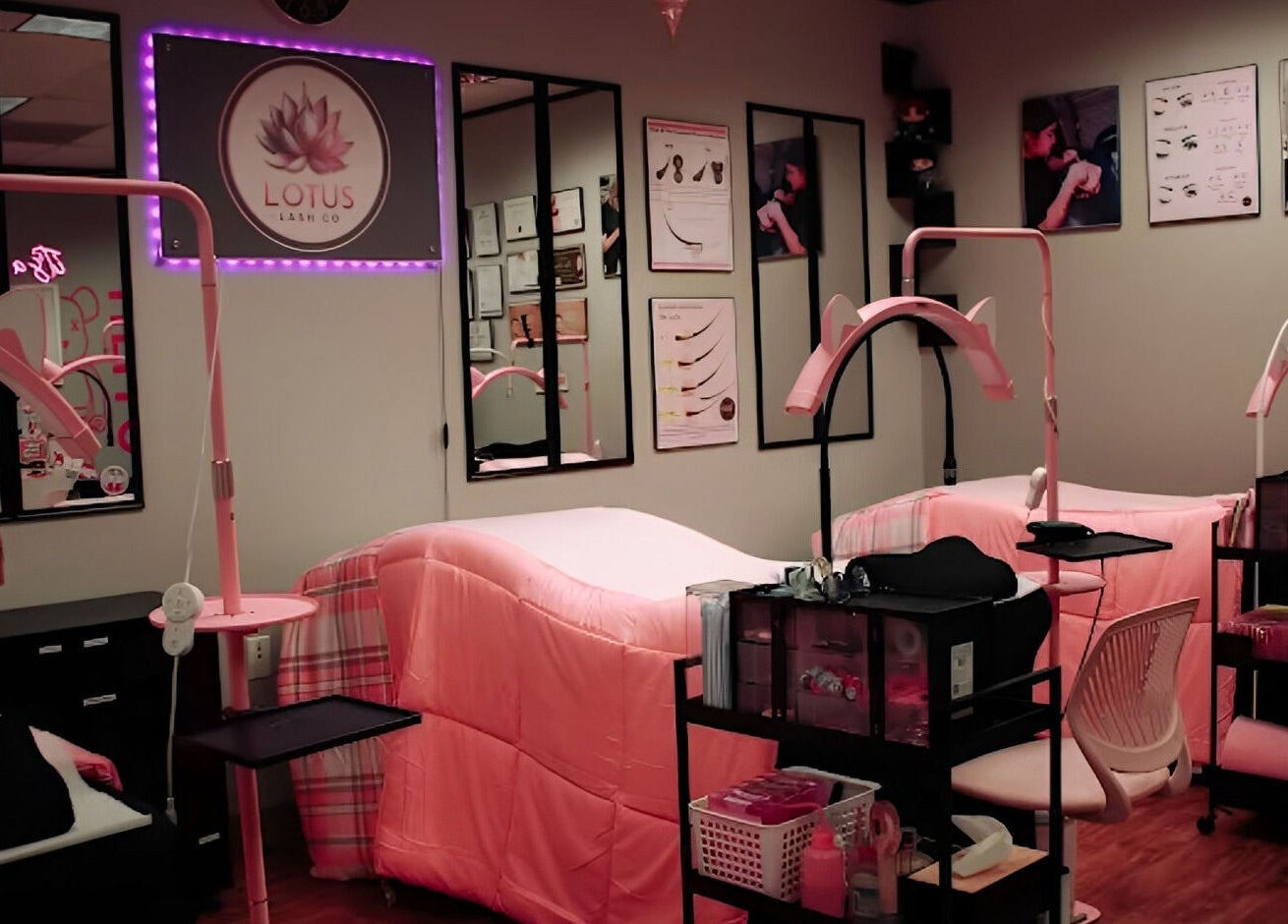 Cozy interior of Lotus Lash Co in Stafford, Texas, US featuring pink treatment beds and elegant decor.
