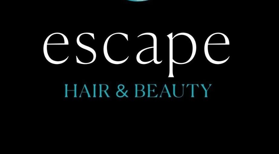 Elegant logo of Escape Hair & Beauty, located in London, England, GB, on a sleek black background.