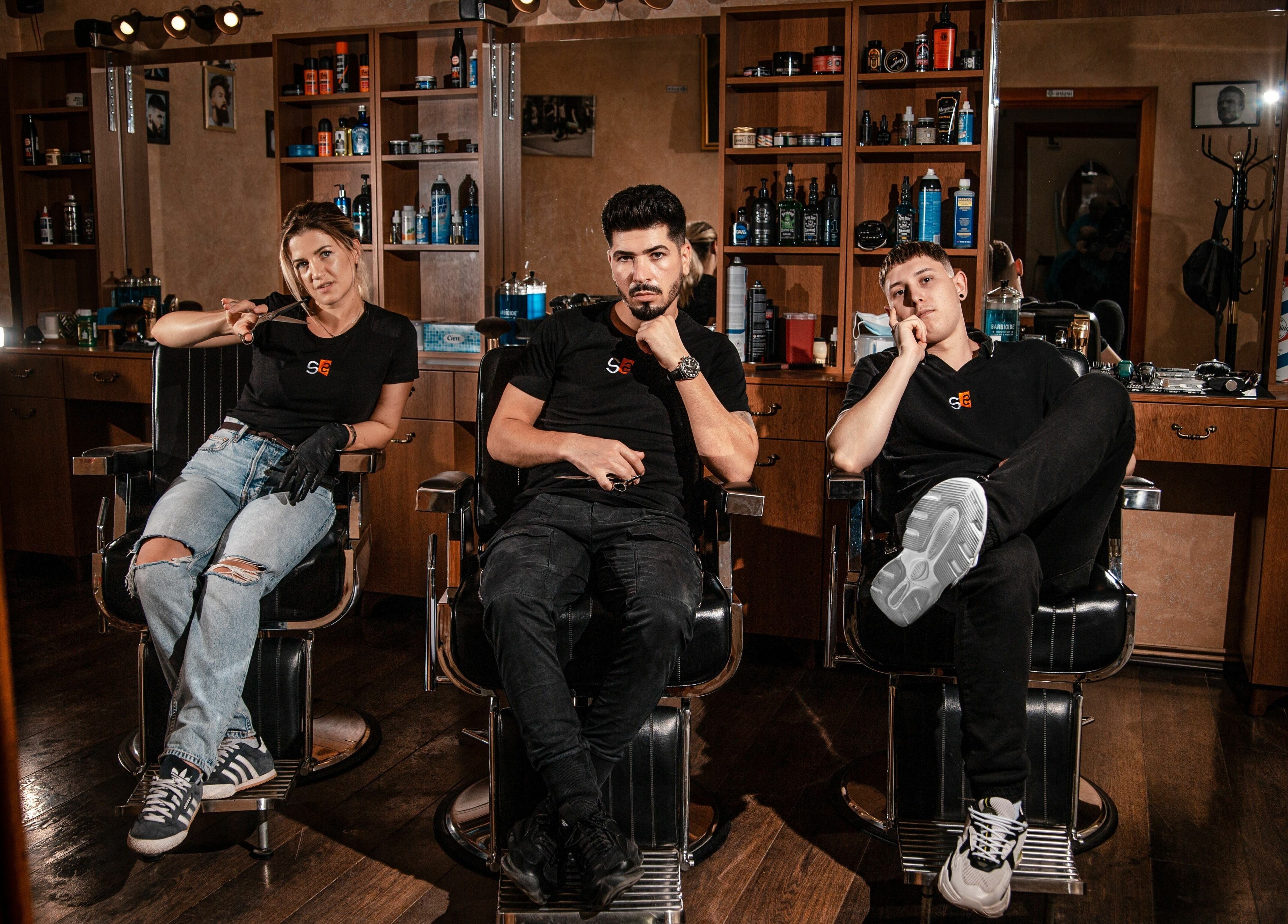 Echipa de stilisti a salonului Stelian din Mizil, Județul Prahova, RO, stând pe scaune de coafor.