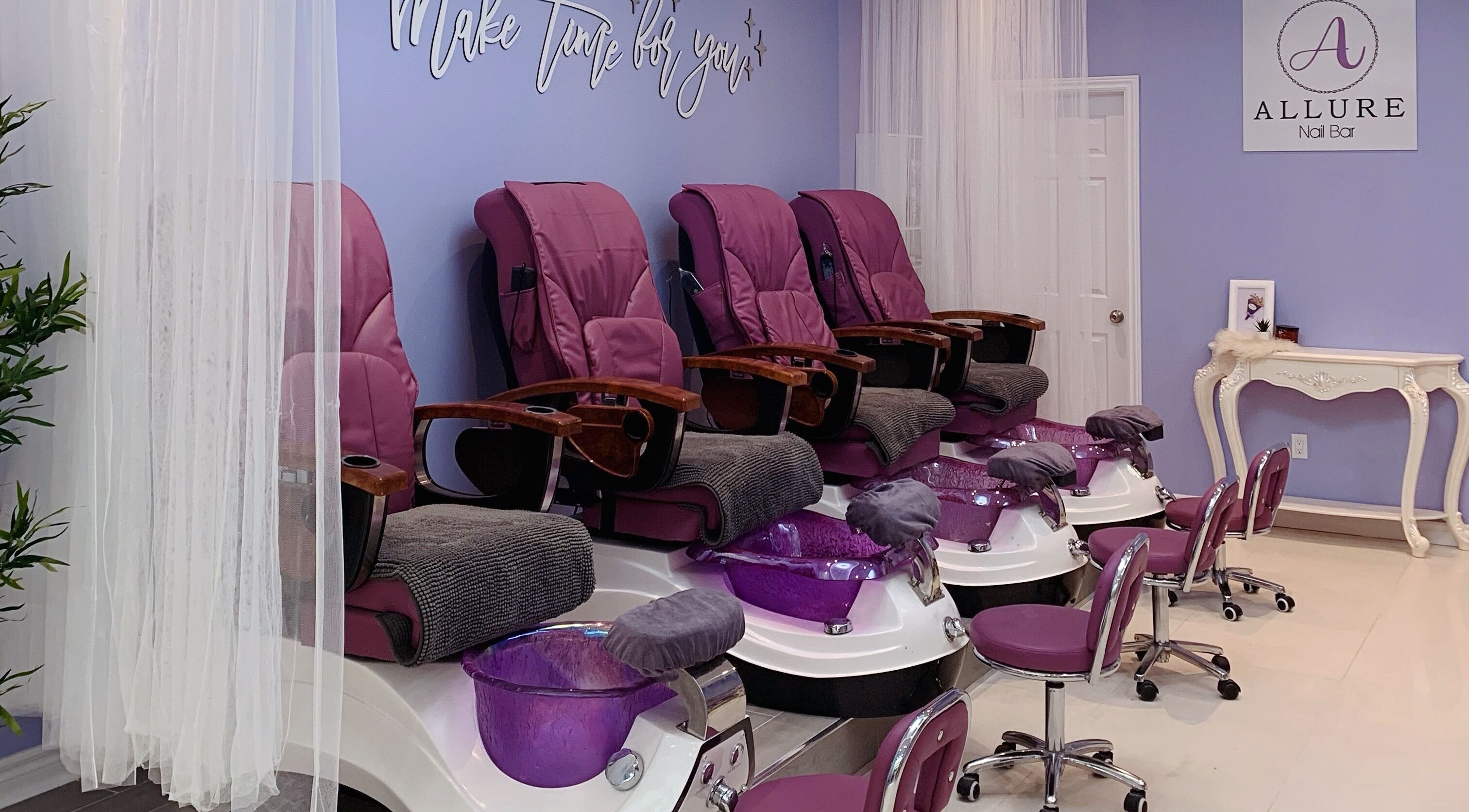Luxurious pedicure chairs at Allure Nail Bar, Mississauga, Ontario, CA offer relaxation and style.