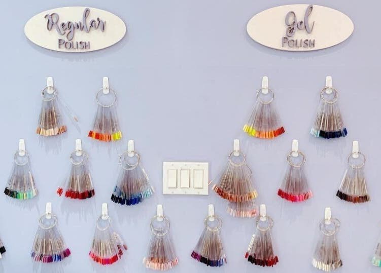 Nail polish display at Allure Nail Bar, Mississauga, Ontario, CA showcasing regular and gel polish options.