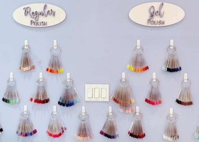 Nail polish display at Allure Nail Bar, Mississauga, Ontario, CA showcasing regular and gel polish options.